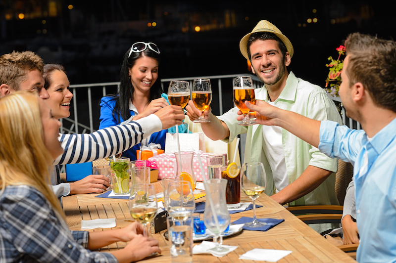 Group of young friends drinking beer outdoors