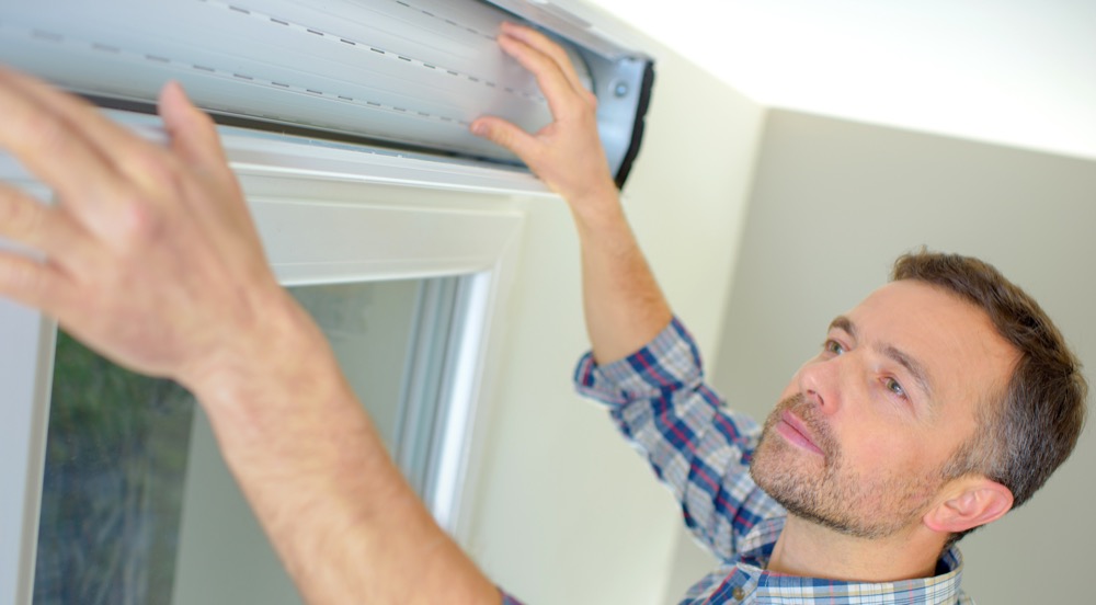 Handyman installing a window shutter