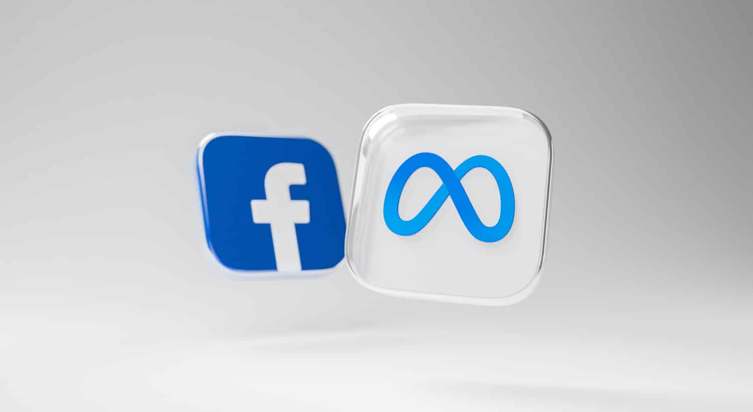 3D-Icons von Facebook und Meta vor grauem Hintergrund