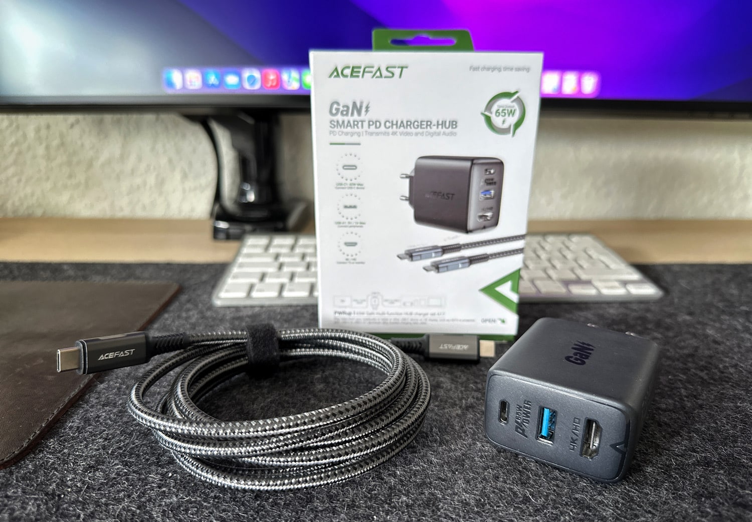 Acefast GaN 65W charger with USB-C charging cable and package on a desk