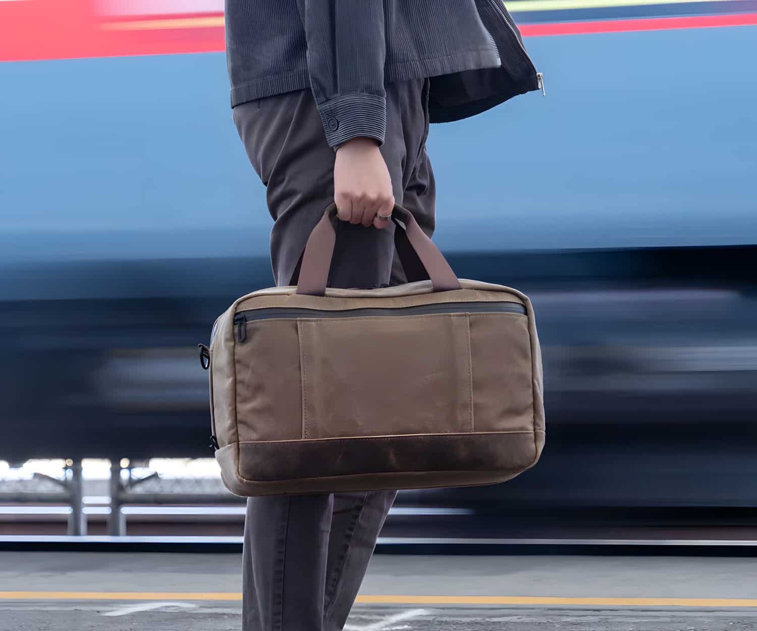 Eine Person trägt eine braune Waterfield Shinjuku Duffel-Tasche
