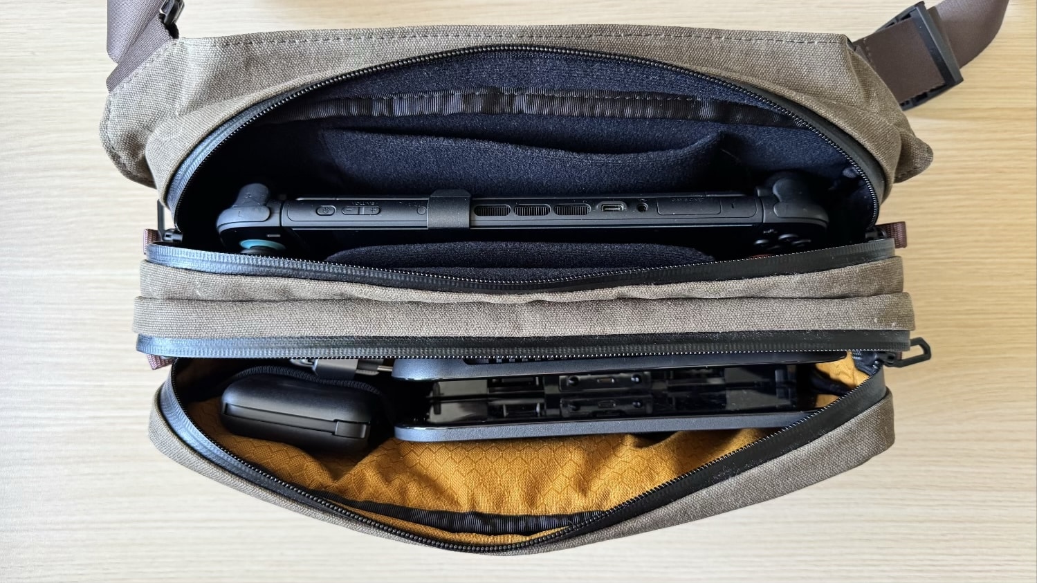 Draufsicht der WaterField Versus Gaming Sling mit Switch 2, Dock und Zubehör.