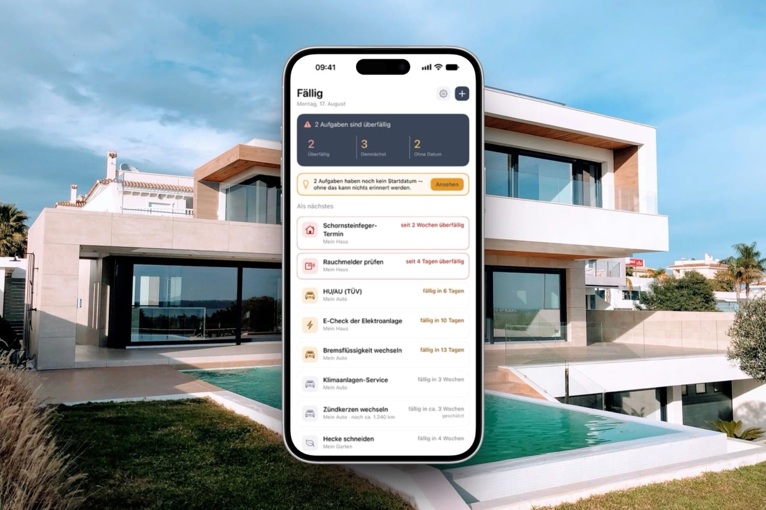 Fällig-App auf einem iPhone vor einer Hauskulisse